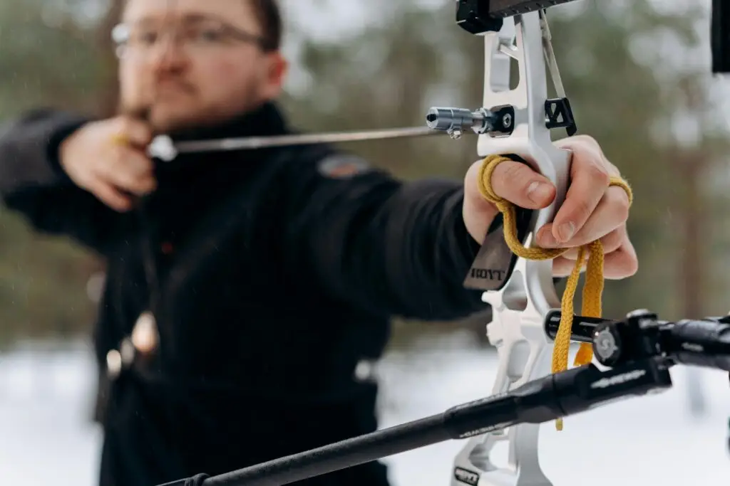 A focused archer drawing a bow with precision, highlighting hand–eye coordination and fast reaction control.